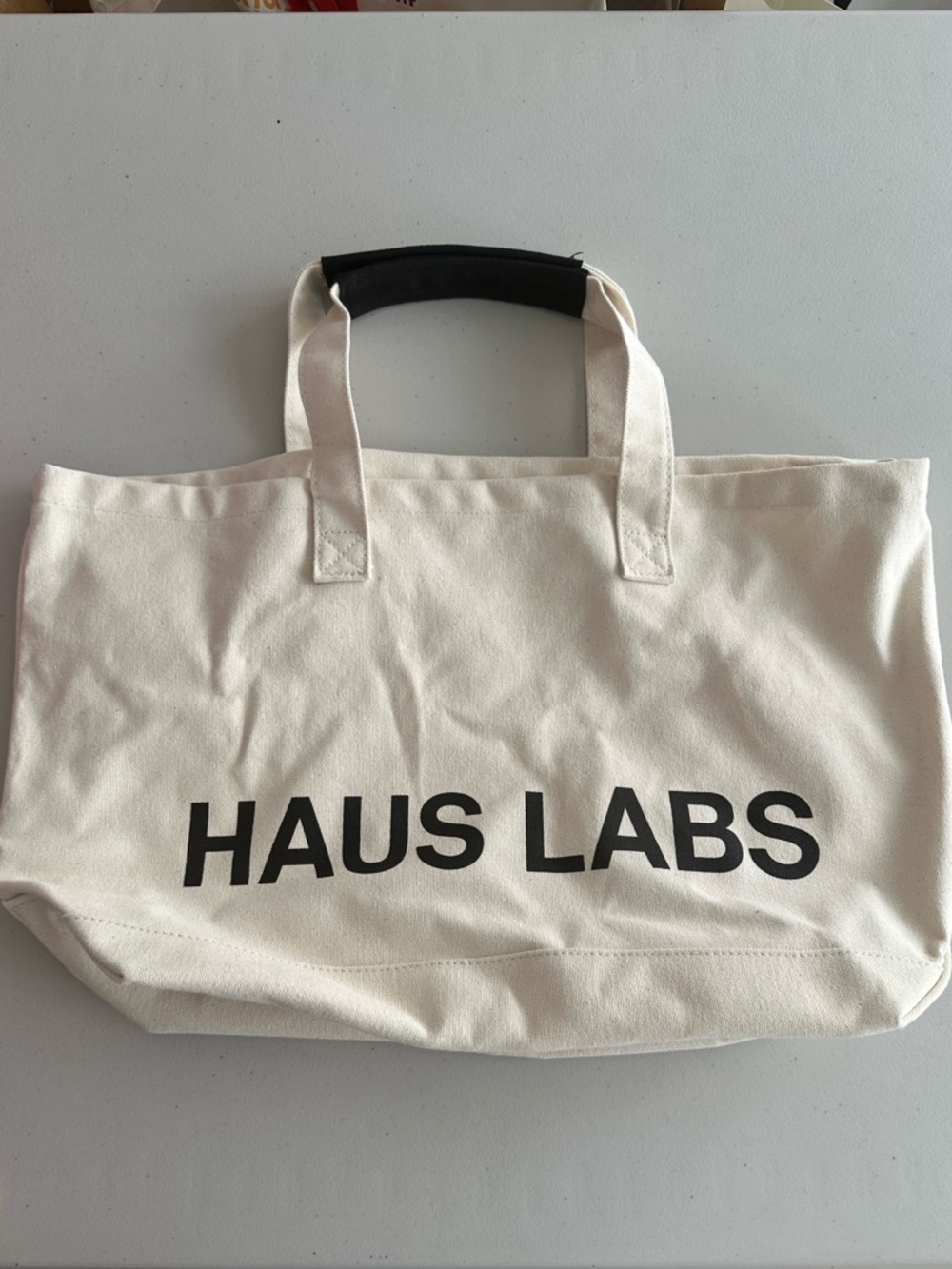HAUS LABS Canvas Tote Bag in Cream with Black Logo lady Gaga